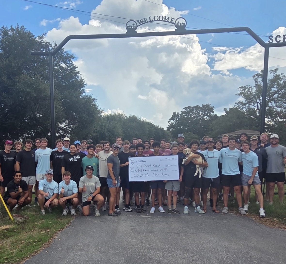 One Army members presenting a donation to Still Creek Ranch