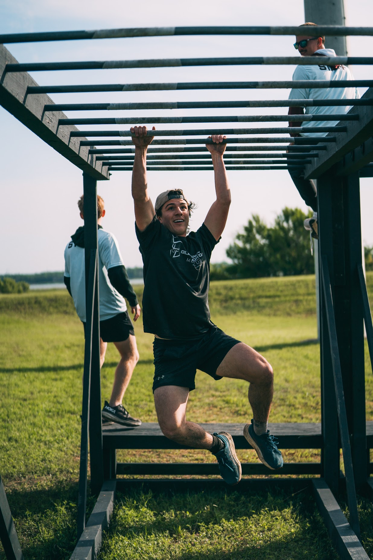 Racer completing the Monkey Bars obstacle